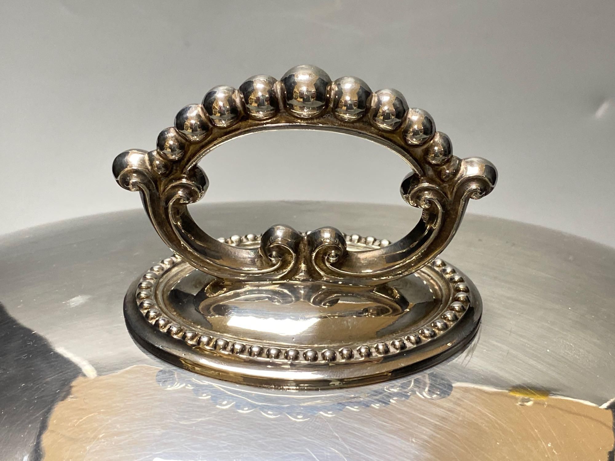 A silver plated engraved meat dome, width 33cm